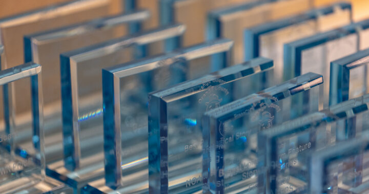 Glass trophies lined up on a table